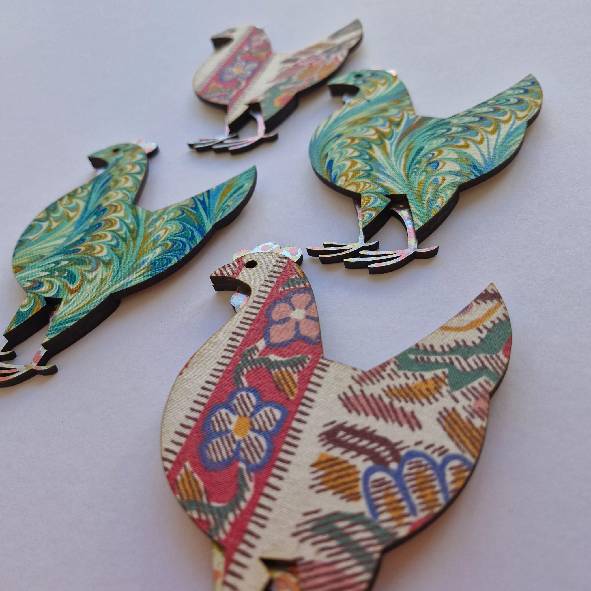 4 laser cut roosters decorated with vintage fabrics and papers