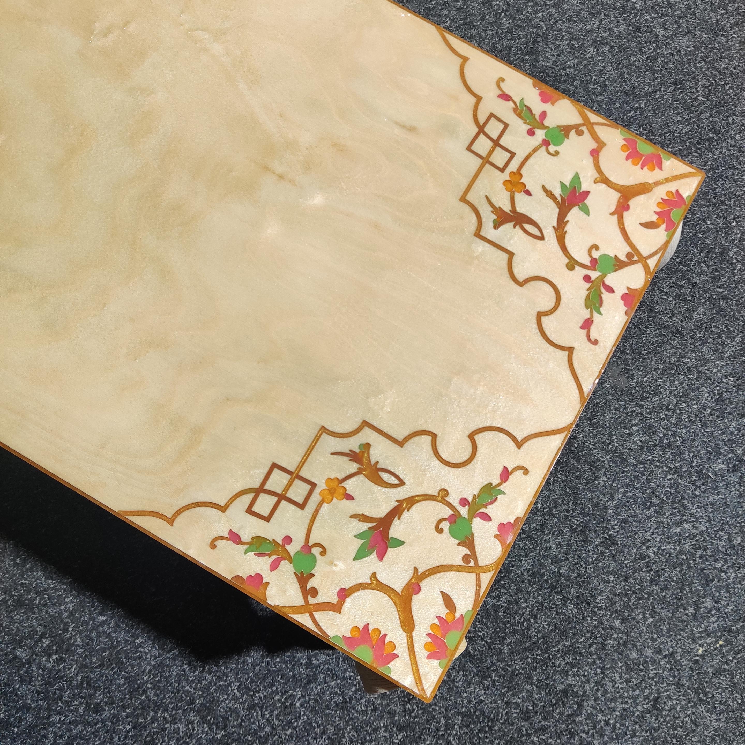 Top of ply coffee table, with CNC routed design filled with coloured resin.