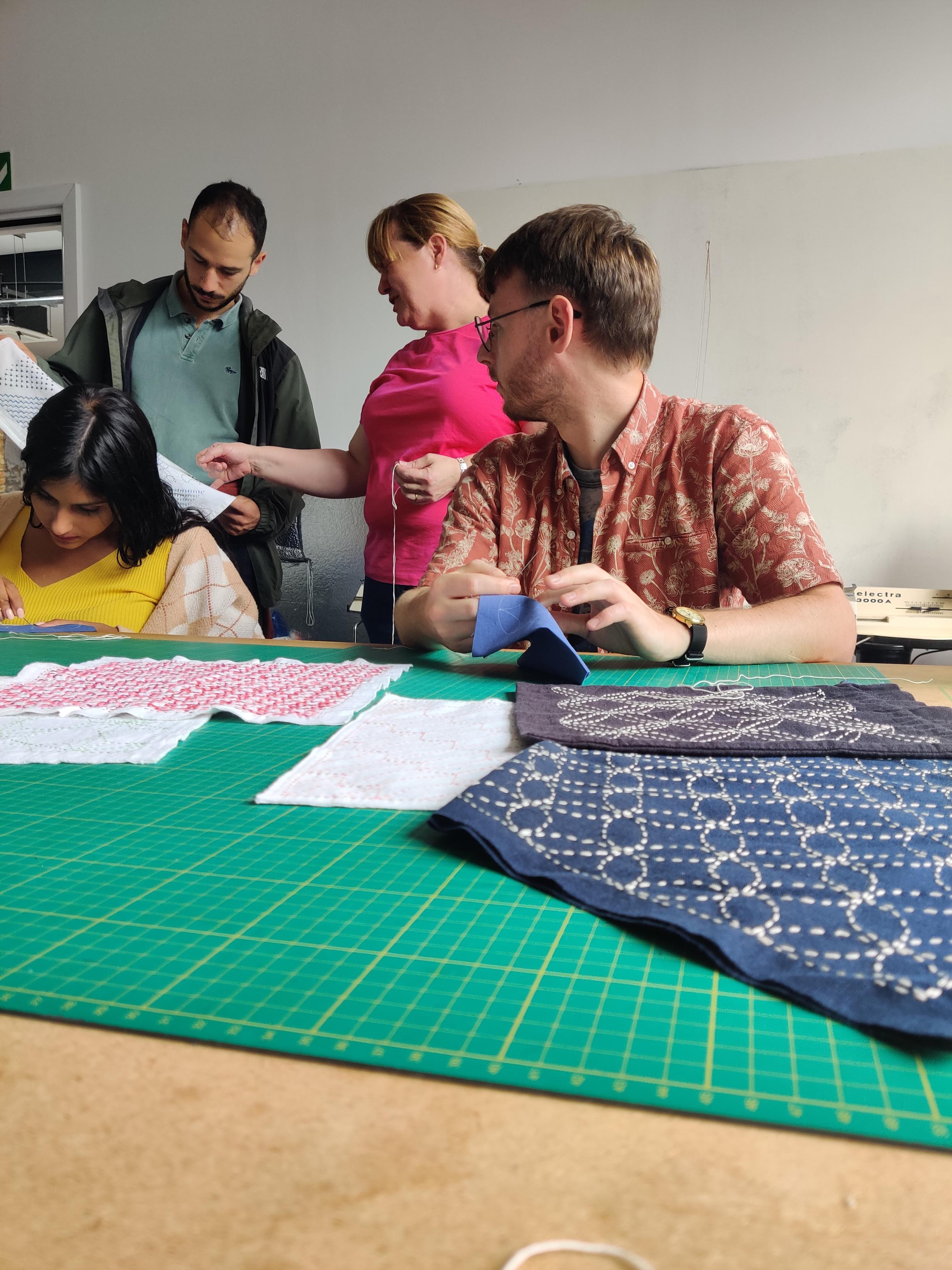 Liz explaining a sashiko pattern to visitors