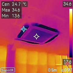 The photo taken by the infrared camera of the DoES Liverpool co-working room. The windows are orange, showing that they're the warmest bit of the photo at 34.6 degrees C, and the vents of the HVAC unit are black bars as they're the coldest parts of the photo, a refreshing 13.6 degrees C