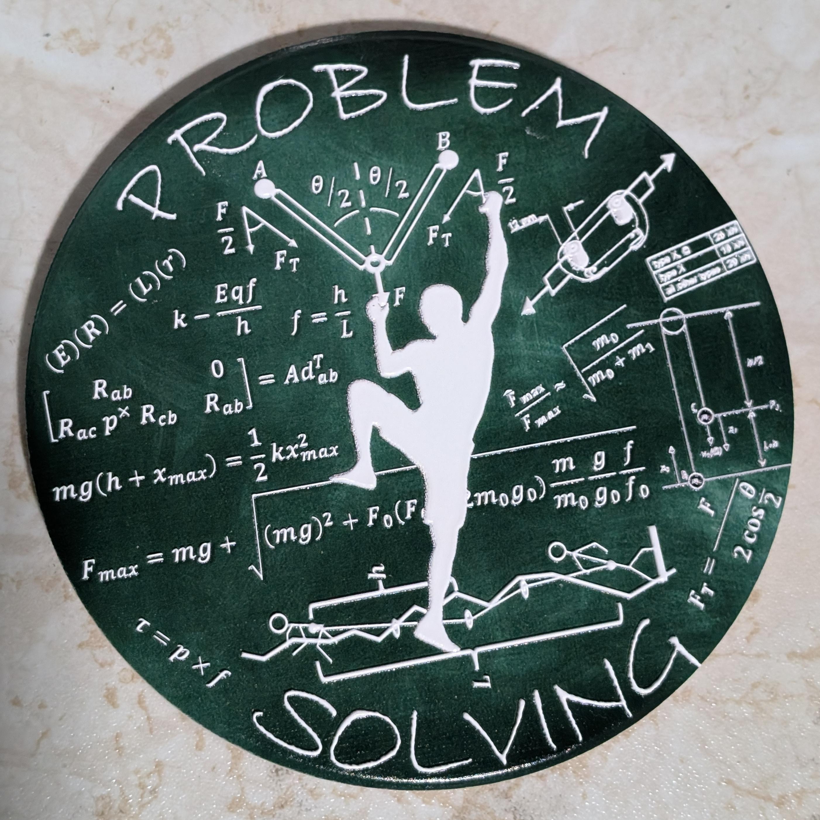 Photo of a coaster with a textured outline of a rock climber, words 