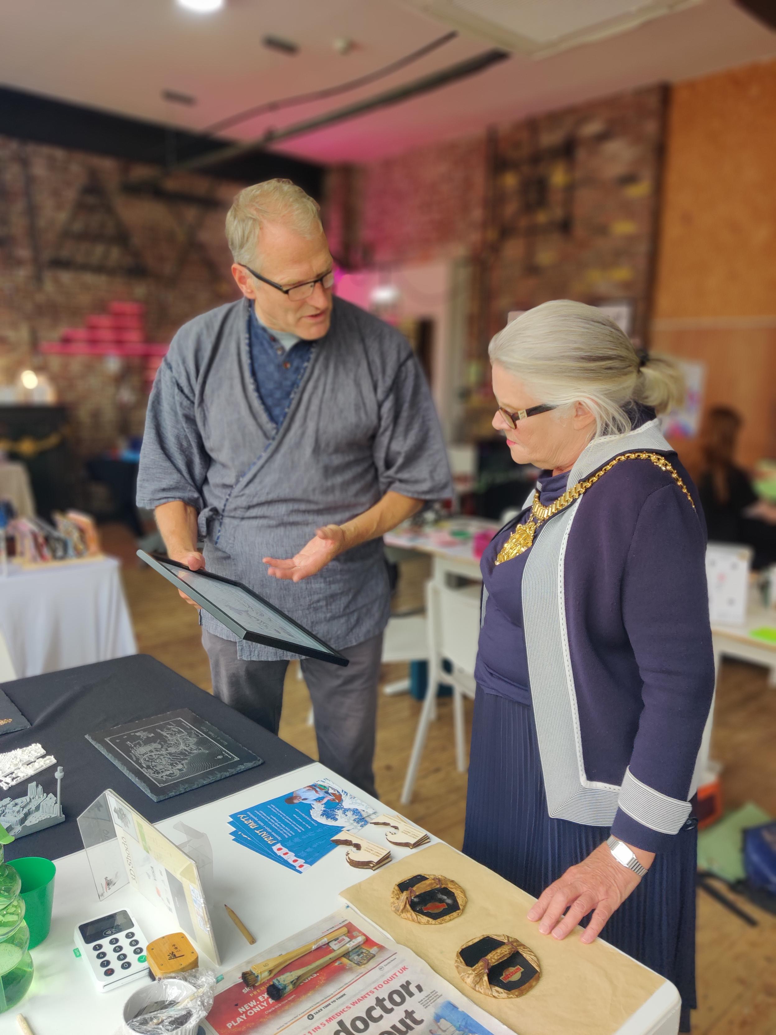 Andy Green and Lord Mayor Barbara Green with Japanese-style woodcut prints and equipment 