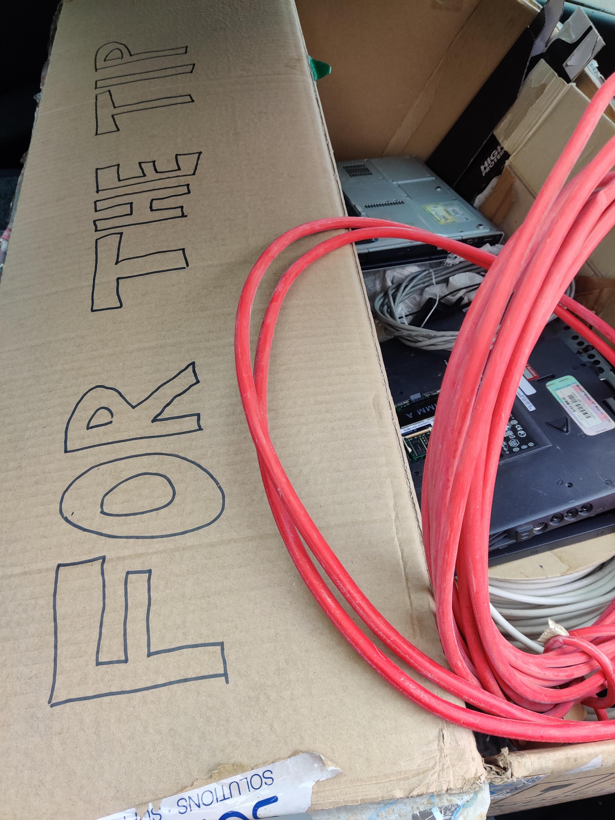 Electronic waste in a cardboard box labelled 