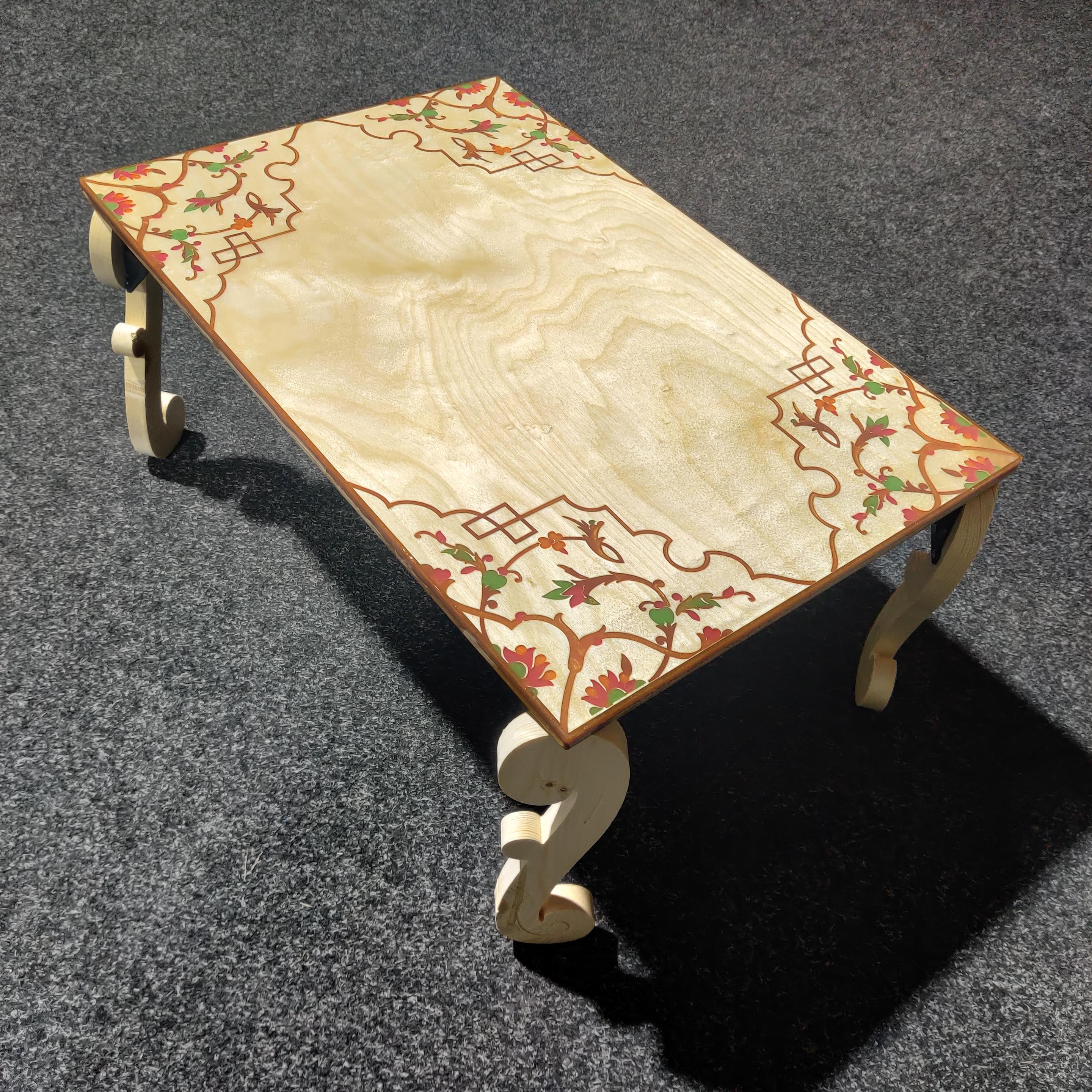 Ply coffee table, with CNC routed design filled with coloured resin, and hinged scroll-shaped legs