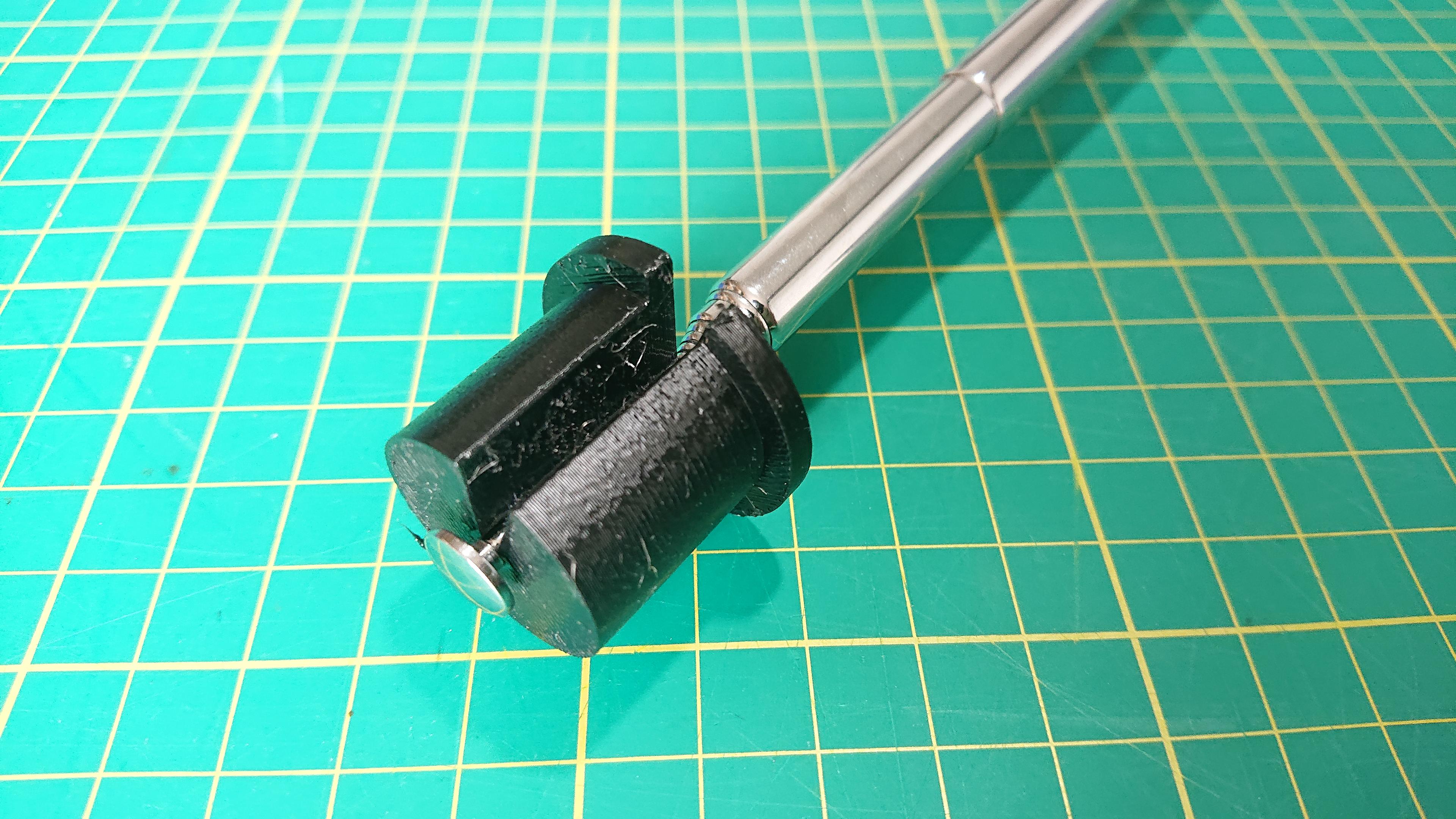 Close up of the 3D printed version clipped round the end of a telescopic aerial