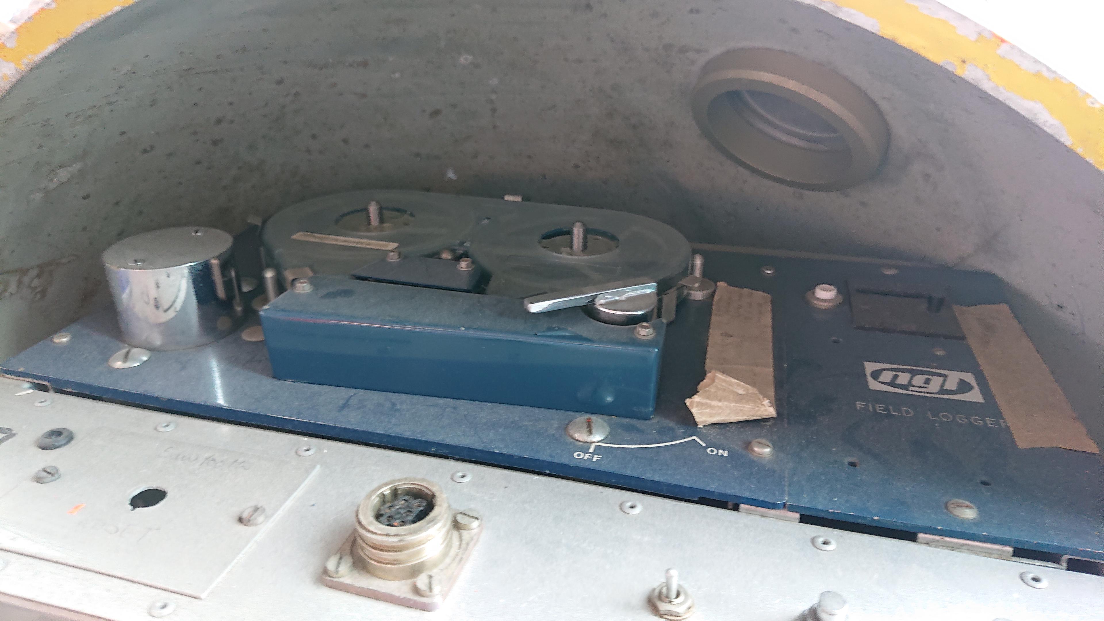 A close up of the internals of the sphere in the last photo, showing the tape recorder, which is labelled with an NGL logo and the text 