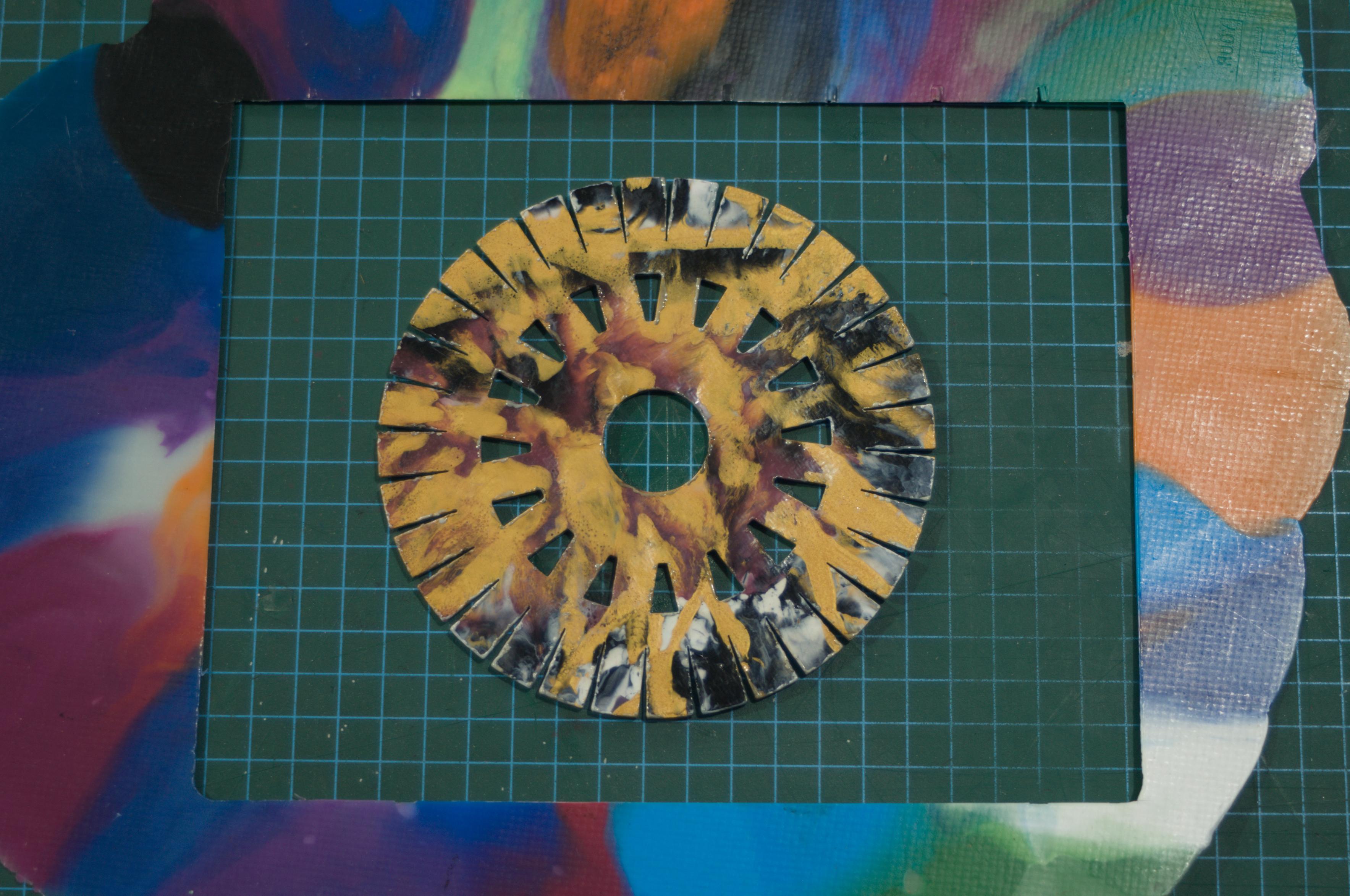 Kumihimo disc made from recycled plastic with swirling colours