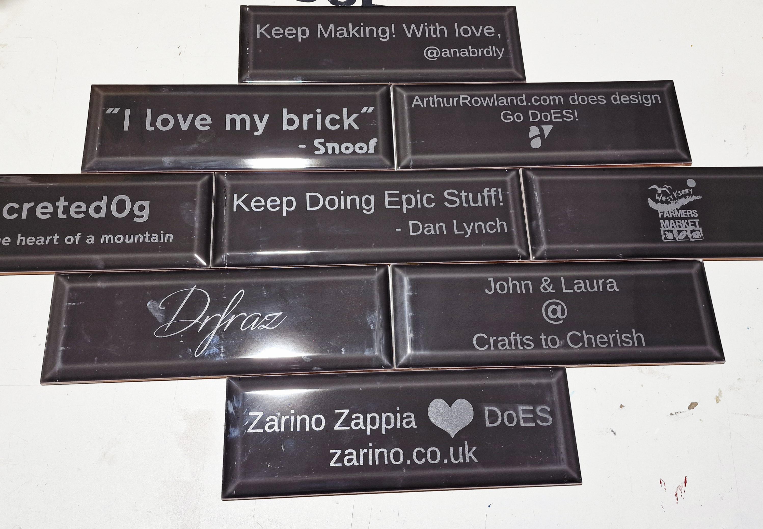 Multiple grey letterbox tiles with laser etched names and messages. Including 