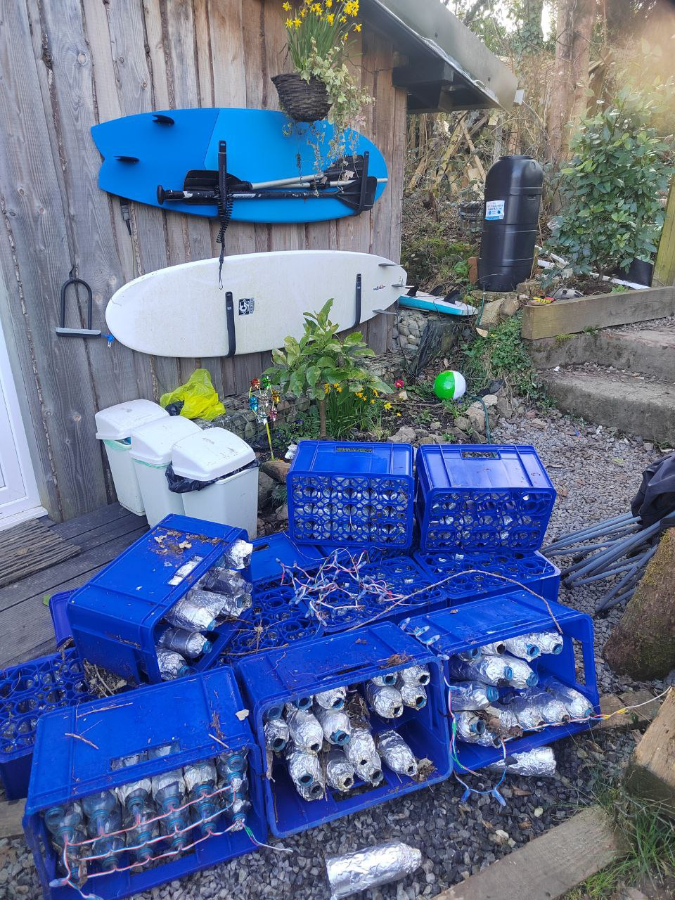 An image of the disused 2D LED matrix display made from recycled plastic bottles and milk crates laying in disrepair in someone's garden, before refurbishment