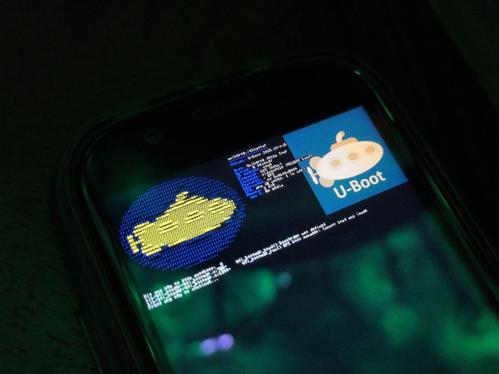 A tiny unihertz jelly star (3 inches!) Screen up close showing the u-boot ufetch boot output